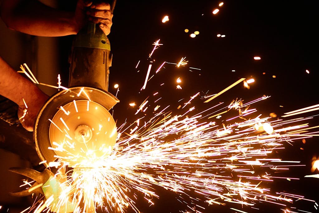 Dynamic shot of an angle grinder emitting bright sparks, showcasing industry power and motion.